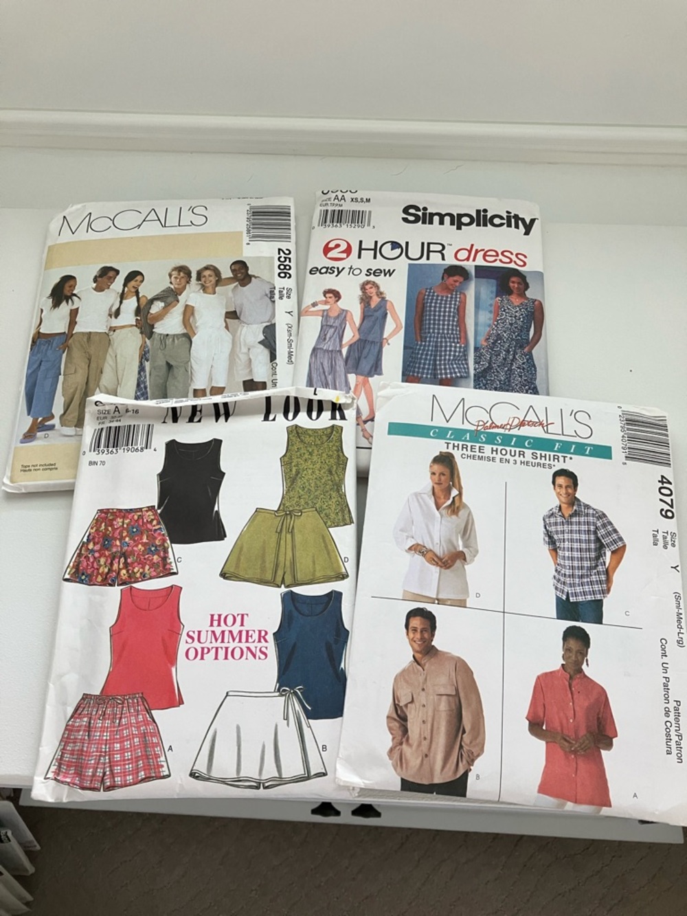 Four uncut sewing patterns sizes extra small to large